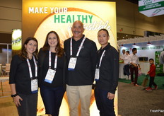 The Zespri team in front of a SunGold kiwi display. From left to right are Catherine DeLettera, Sarah Deaton, Ken Burke, and Shawn Wen.